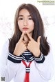 A woman in a sailor outfit posing for a picture.