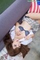 A woman laying on a couch with an American flag on it.