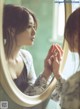 A woman looking at her reflection in a mirror.