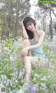 A woman sitting in a field of purple flowers.