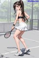 A woman in a black top and white skirt holding a tennis racket.